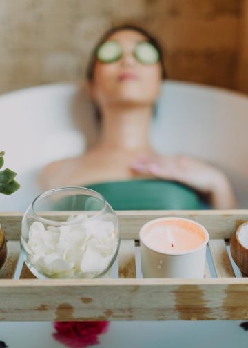Woman in Green Tube Top Sitting on White Ceramic Bathtub